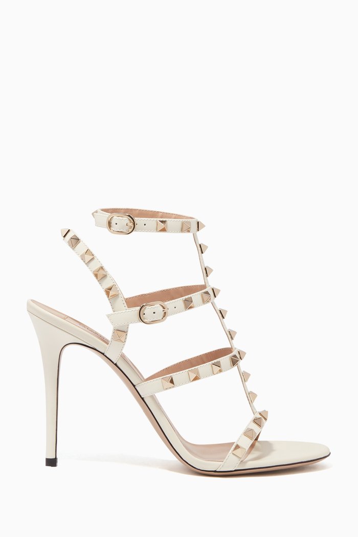 

Valentino Garavani Rockstud Patent Sandals, Neutral